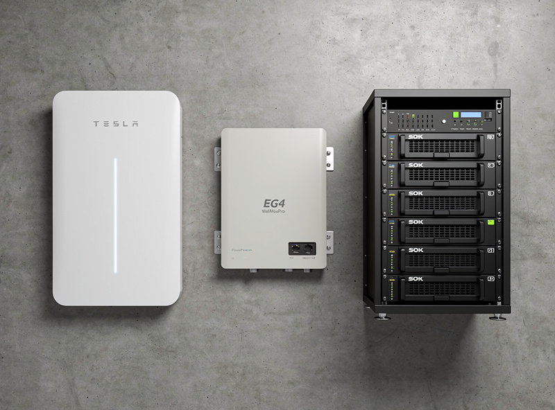 Comparison display of three home battery storage systems: a Tesla Powerwall 3 EG4 PowerPro WallMount and stacked SOK 48V server rack batteries on a workshop wall