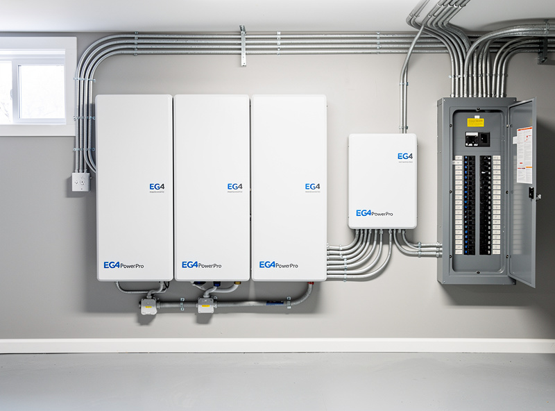 Complete EG4 PowerPro home battery storage installation showing the wall mounted battery hybrid inverter connections and electrical panel integration in a finished basement utility room