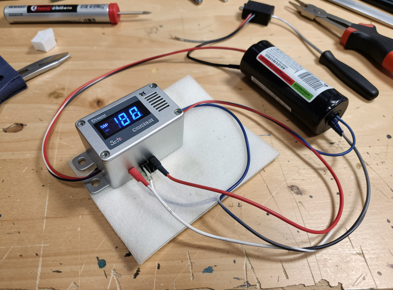 A small DC temperature controller module with a digital display showing a set point