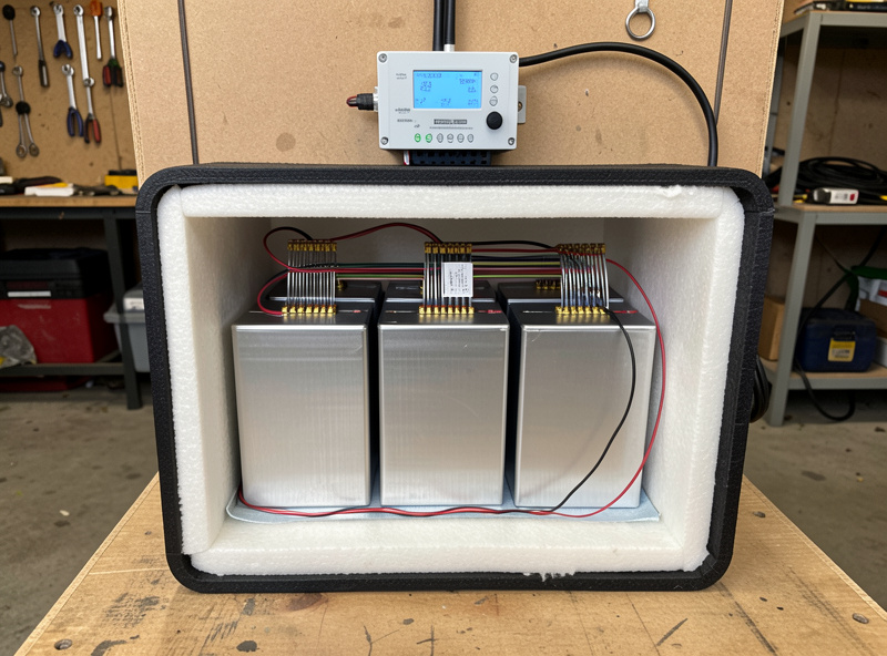 LiFePO4 prismatic battery bank in an insulated enclosure with a heating pad and temperature sensor