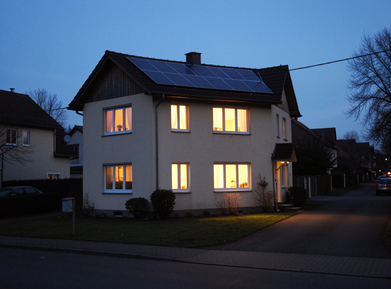 A house at dusk with interior lights on during a neighbourhood power outage